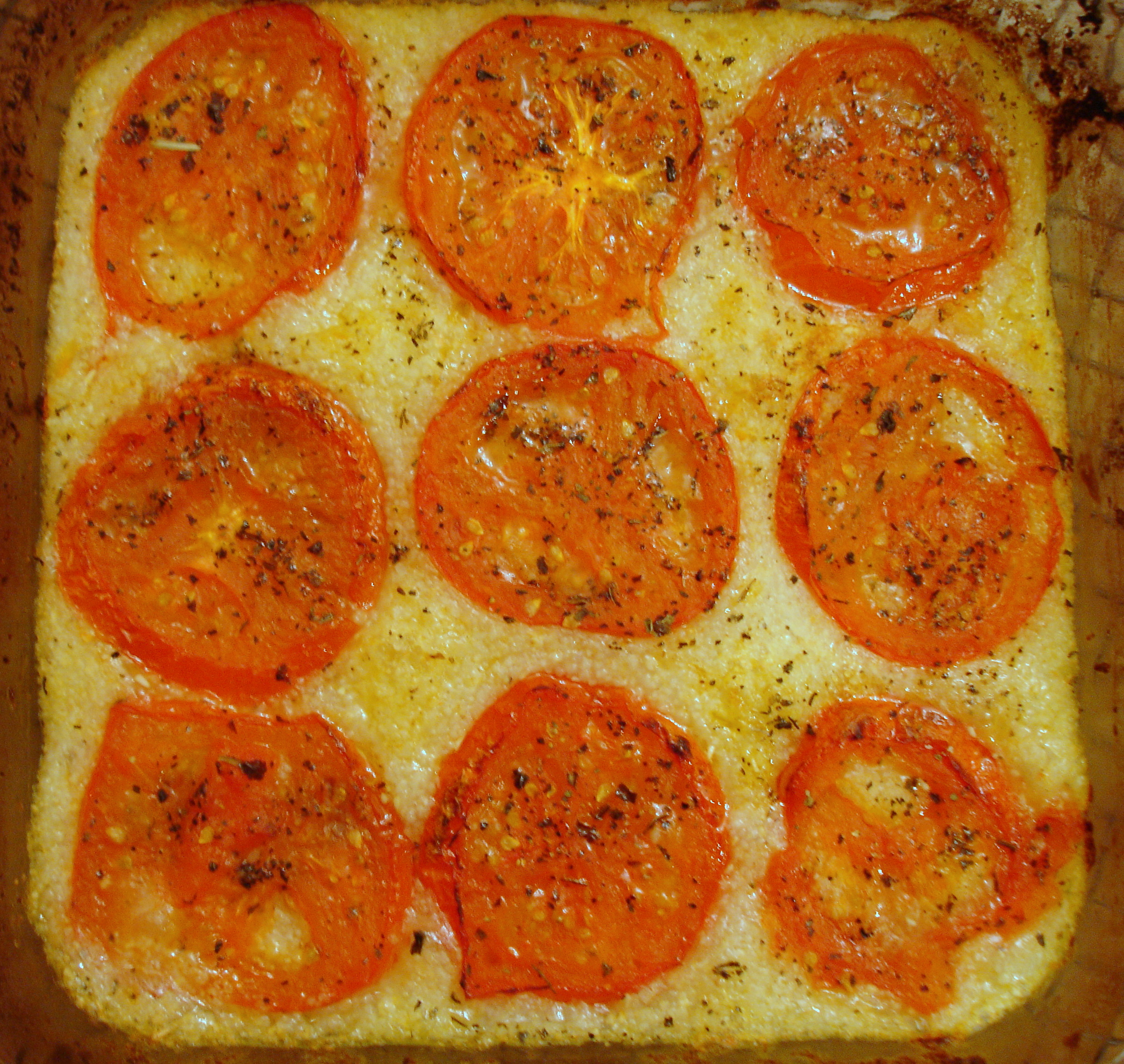 Grits with tomatoes over easy