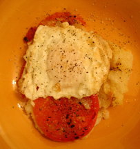 Grits with tomatoes over easy