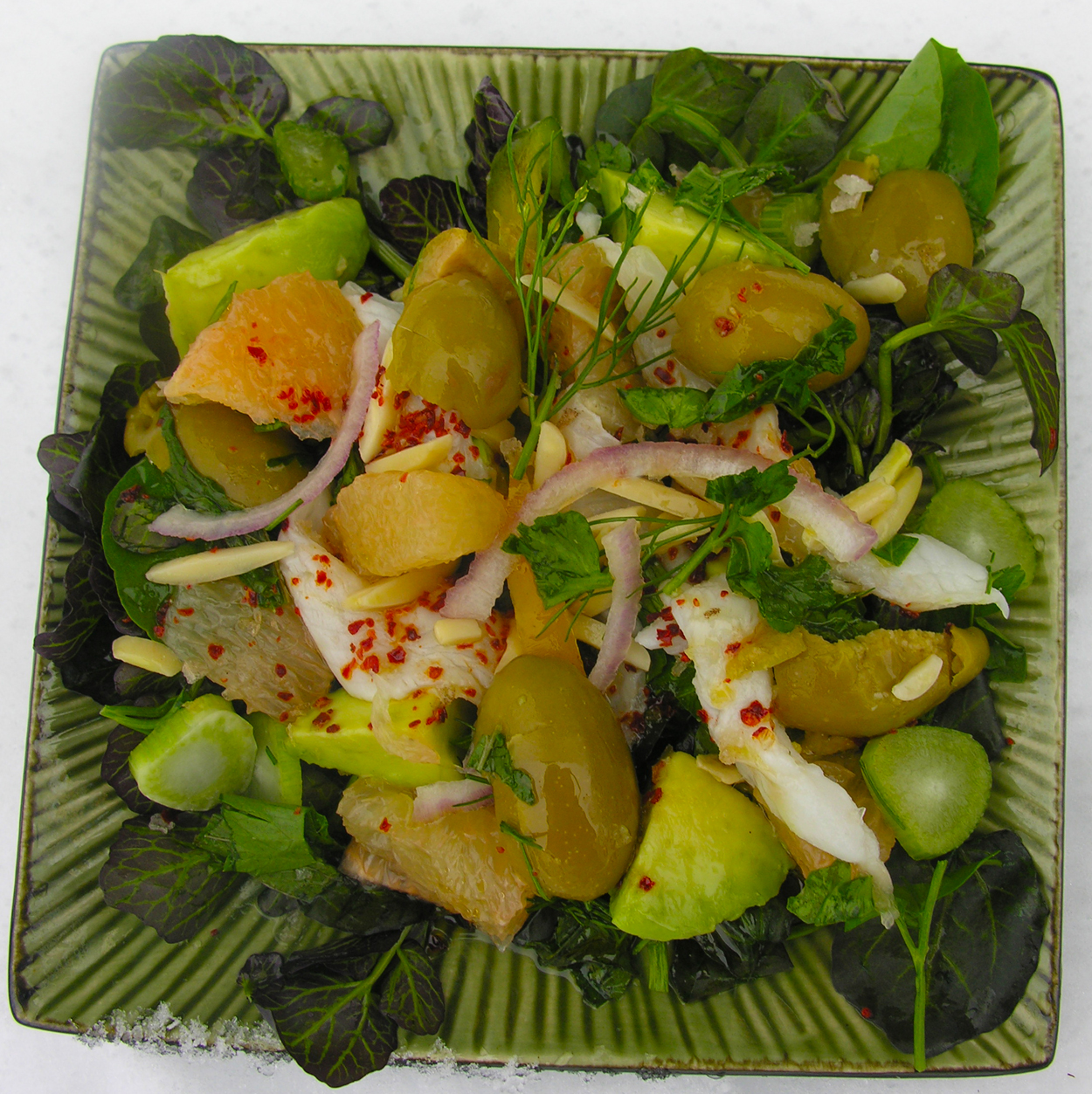 Ceviche with pink grapefruit and green olives