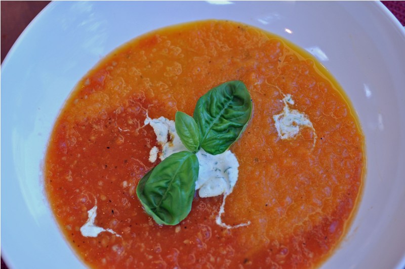 Roasted Carrot & Tomato Soup with a Topping of Basil Infused Creme Fraiche