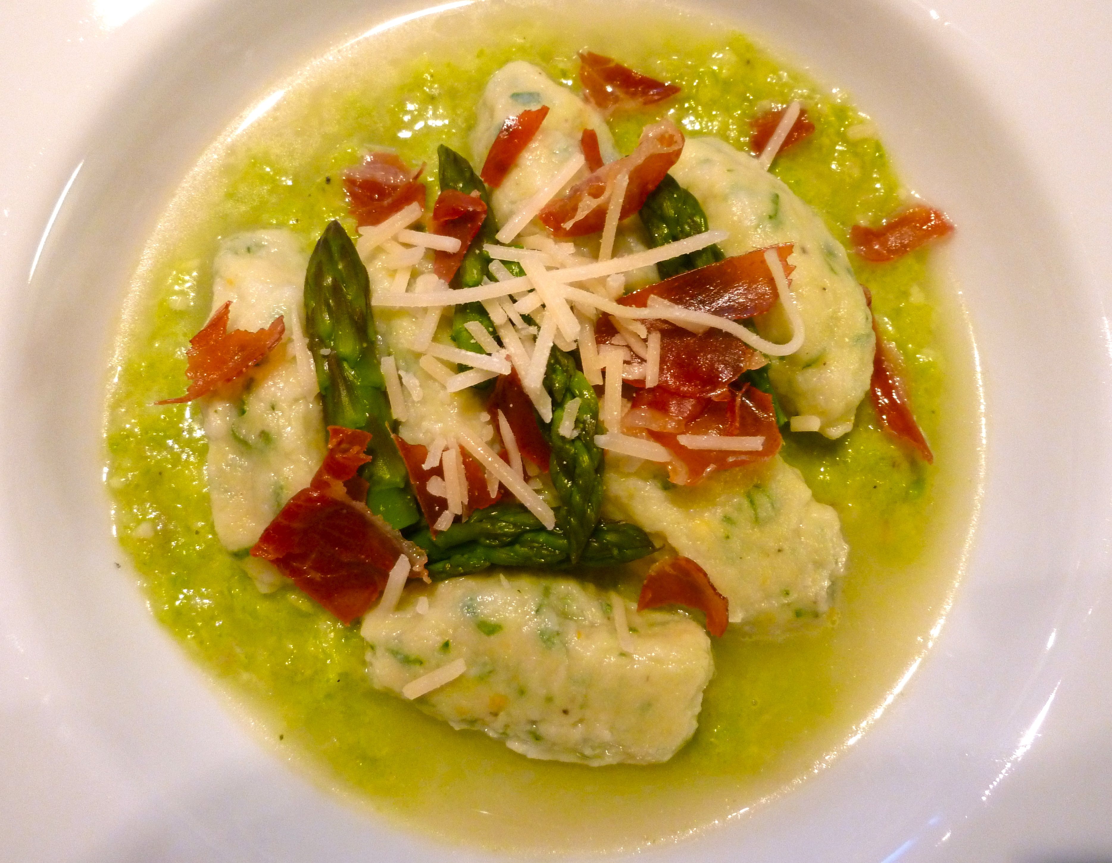 Homemade Goat Milk Ricotta Gnudi on Asparagus Puree in a Parmesan Brodo