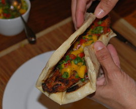 Hot smoked paprika pork with mango salsa in flat bread