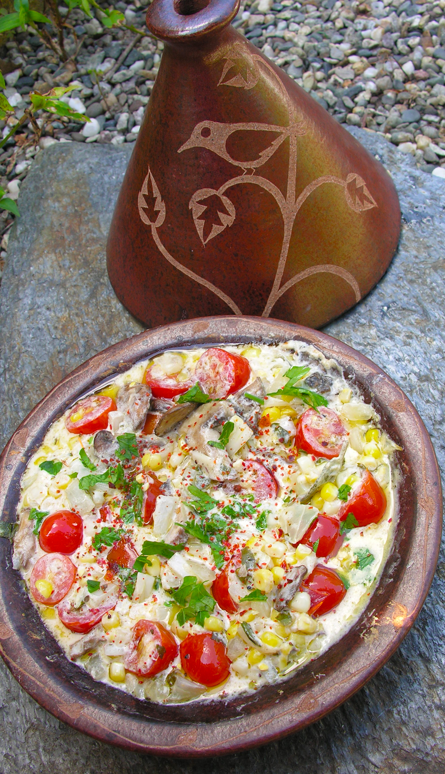 Creamy corn, mushroom and cherry tomatoes cooked in a tagine