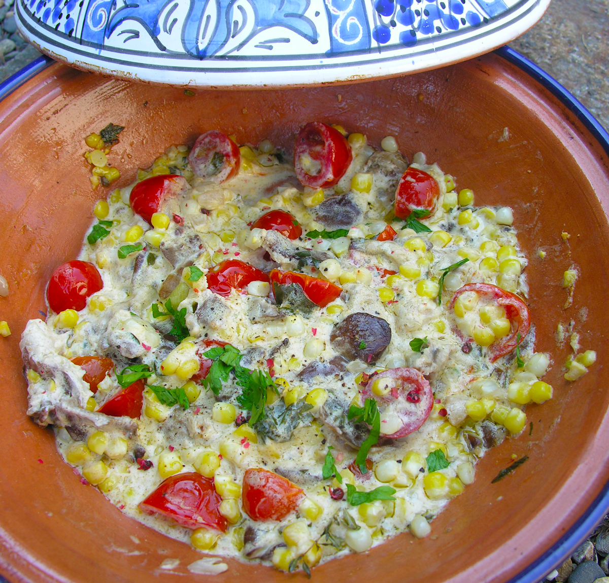 Creamy corn, mushroom and cherry tomatoes cooked in a tagine