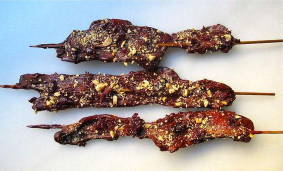 CHOCOLATE COVERED BACON ON A STICK WITH MARCONA ALMONDS AND DRIED CHERRIES