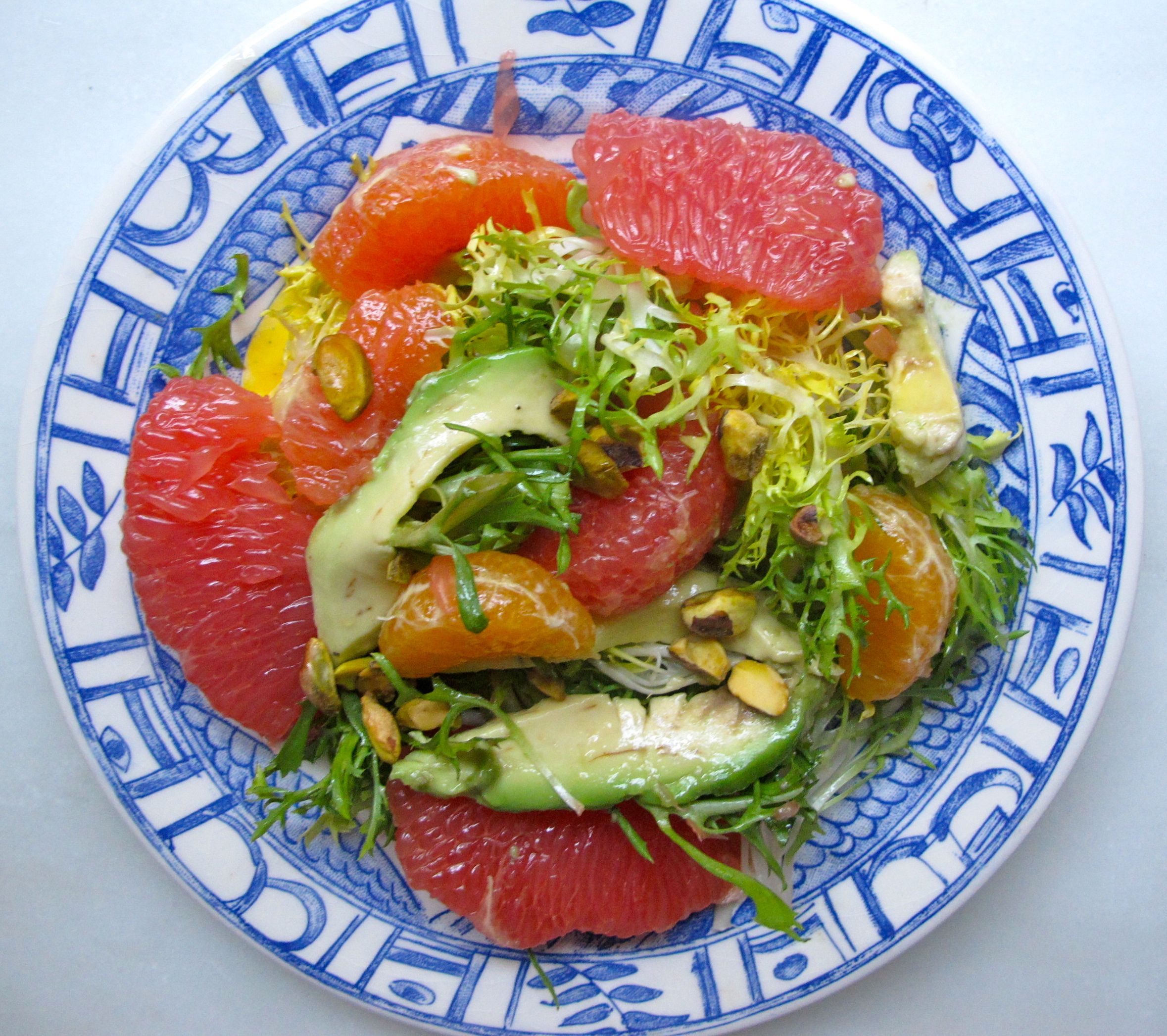 MIXED CITRUS AND AVOCADO ON A BED OF FRISEE