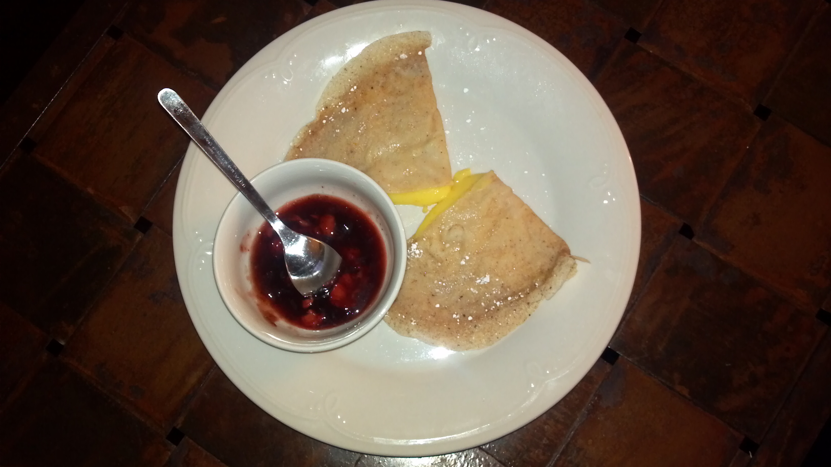 Tangerine Crepes With A Side Of Strawberry Reduction Sauce