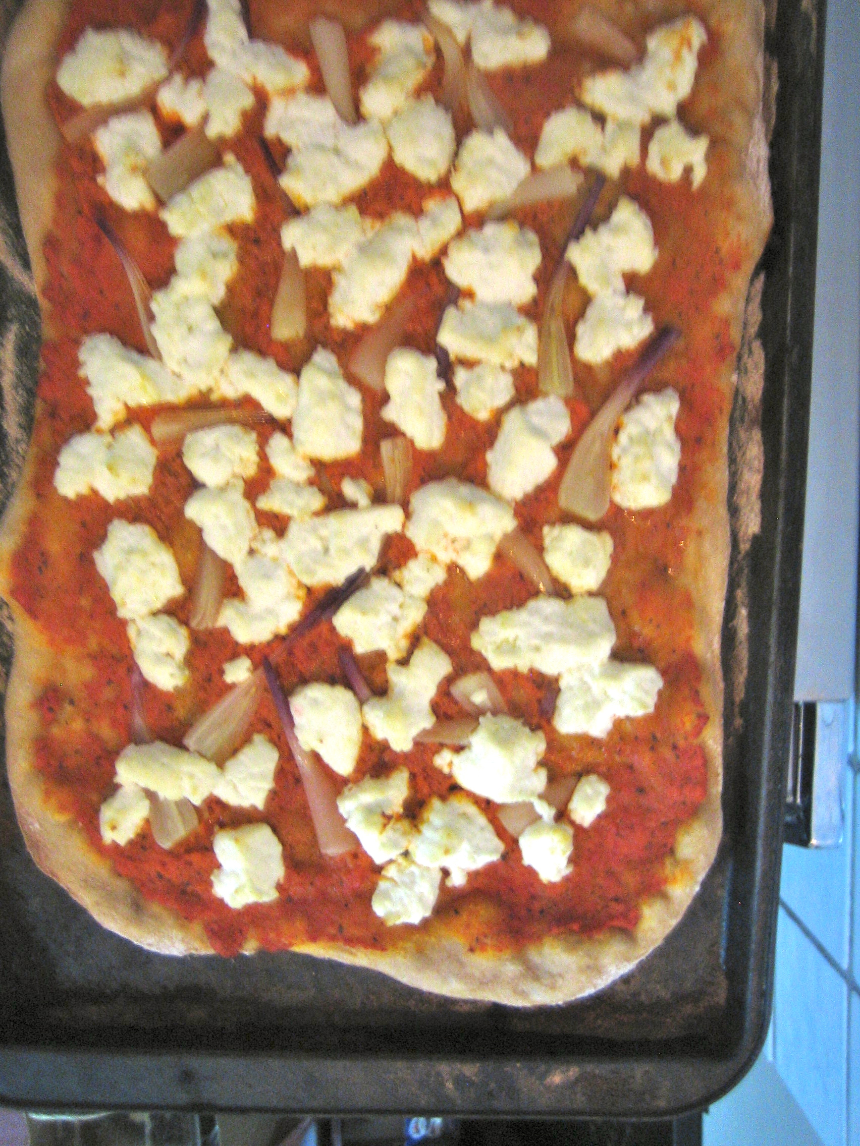 Ramp and Chèvre Pizza with Red Pepper Pesto and Spelt Crust