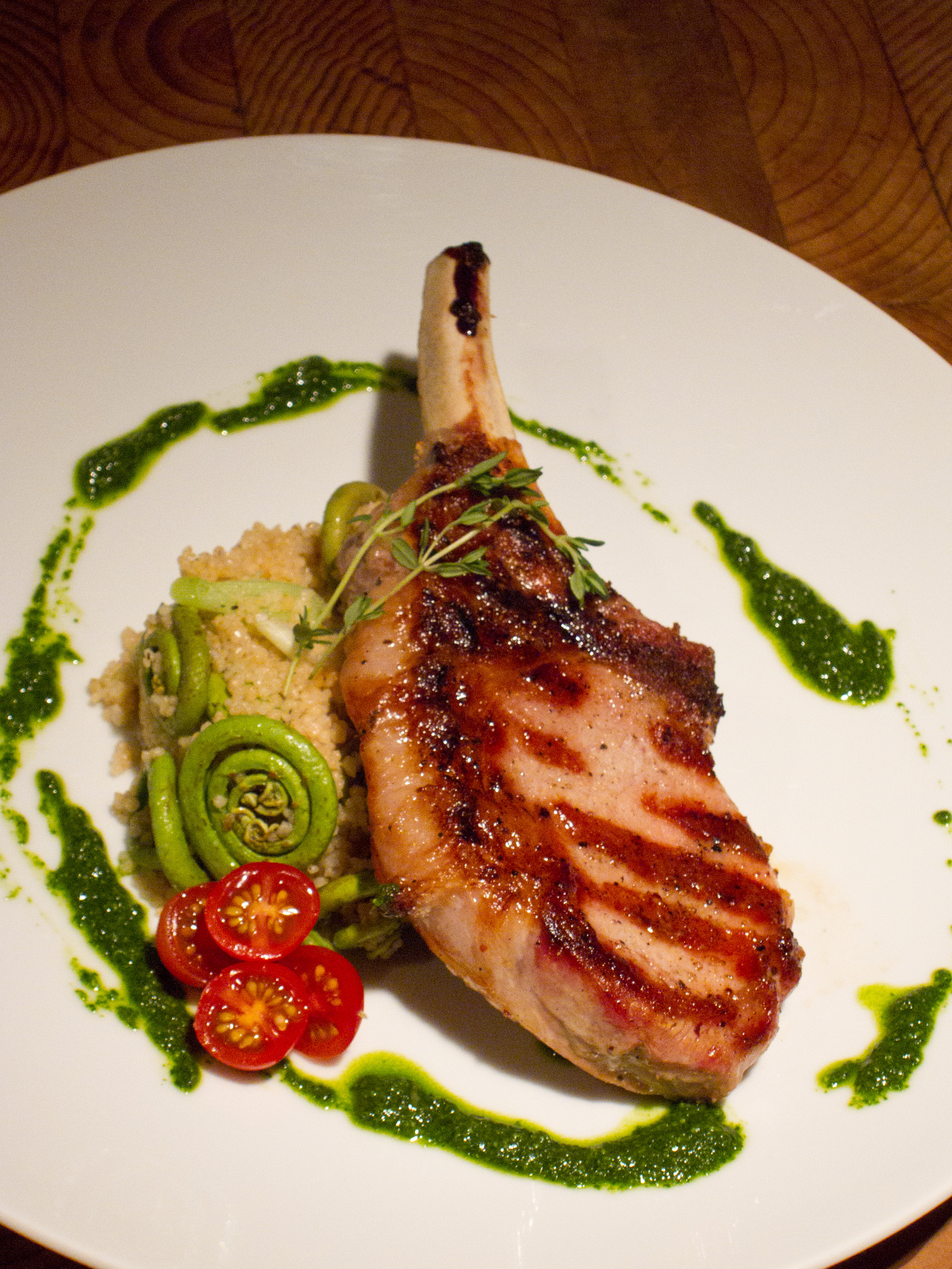 Grilled Pork with Fiddlehead Ferns, Spring Garlic Couscous and Nasturtium Pesto