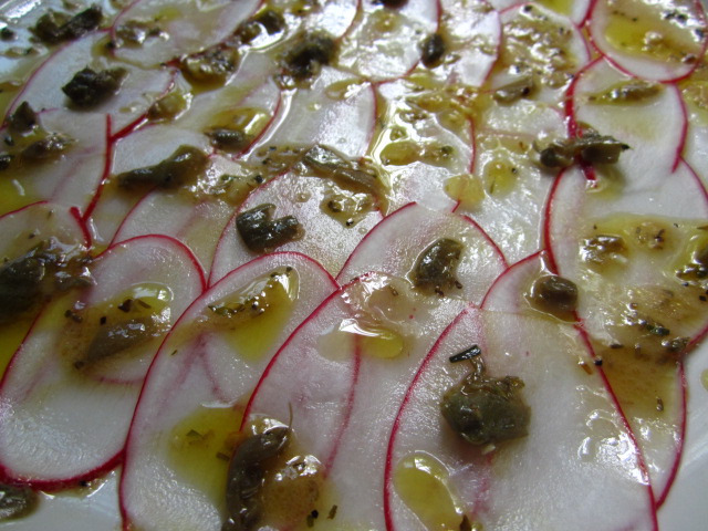 Radish Carpaccio with capers and herbs vinaigrette. 