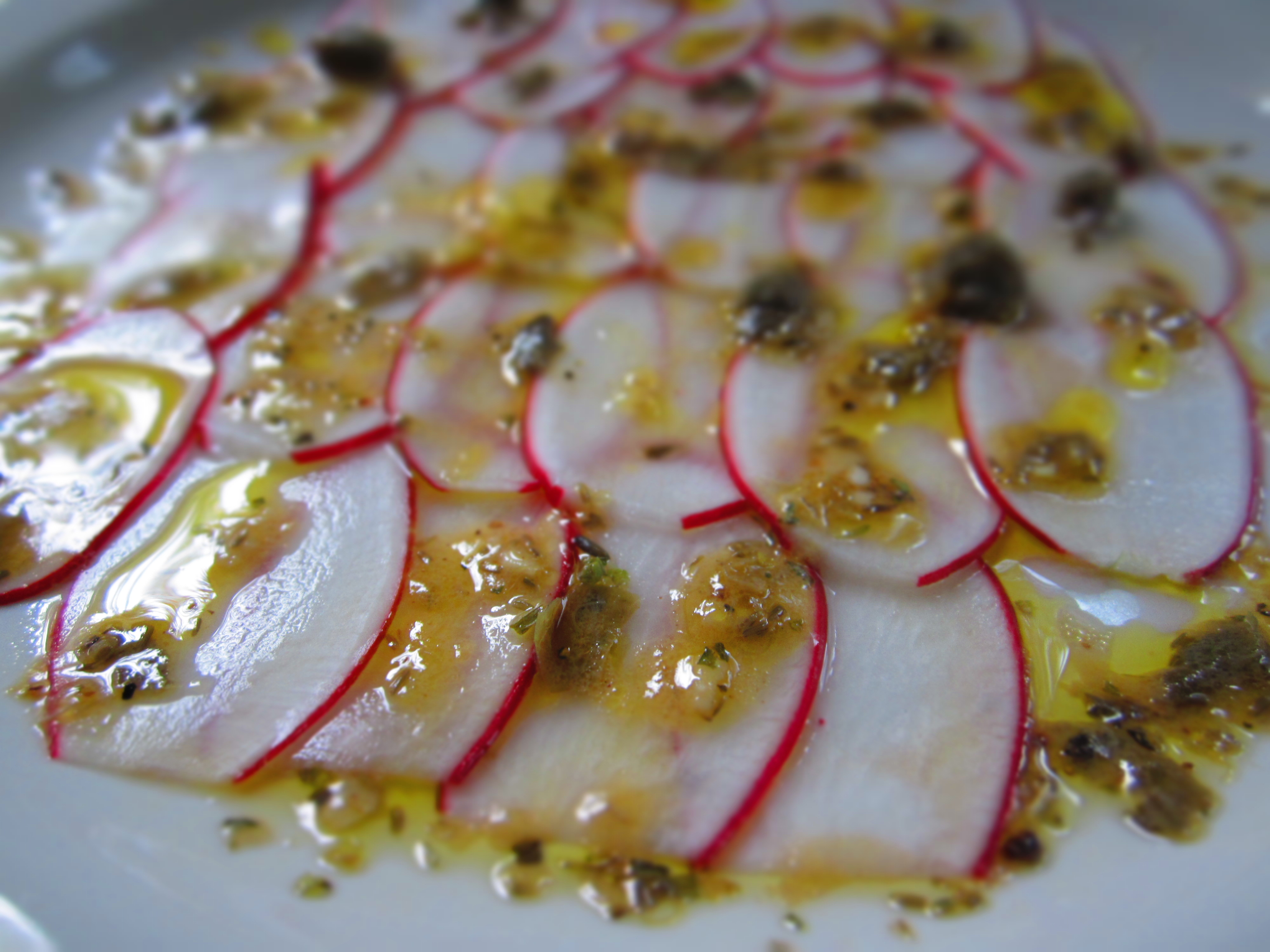 Radish Carpaccio with capers and herbs vinaigrette. 
