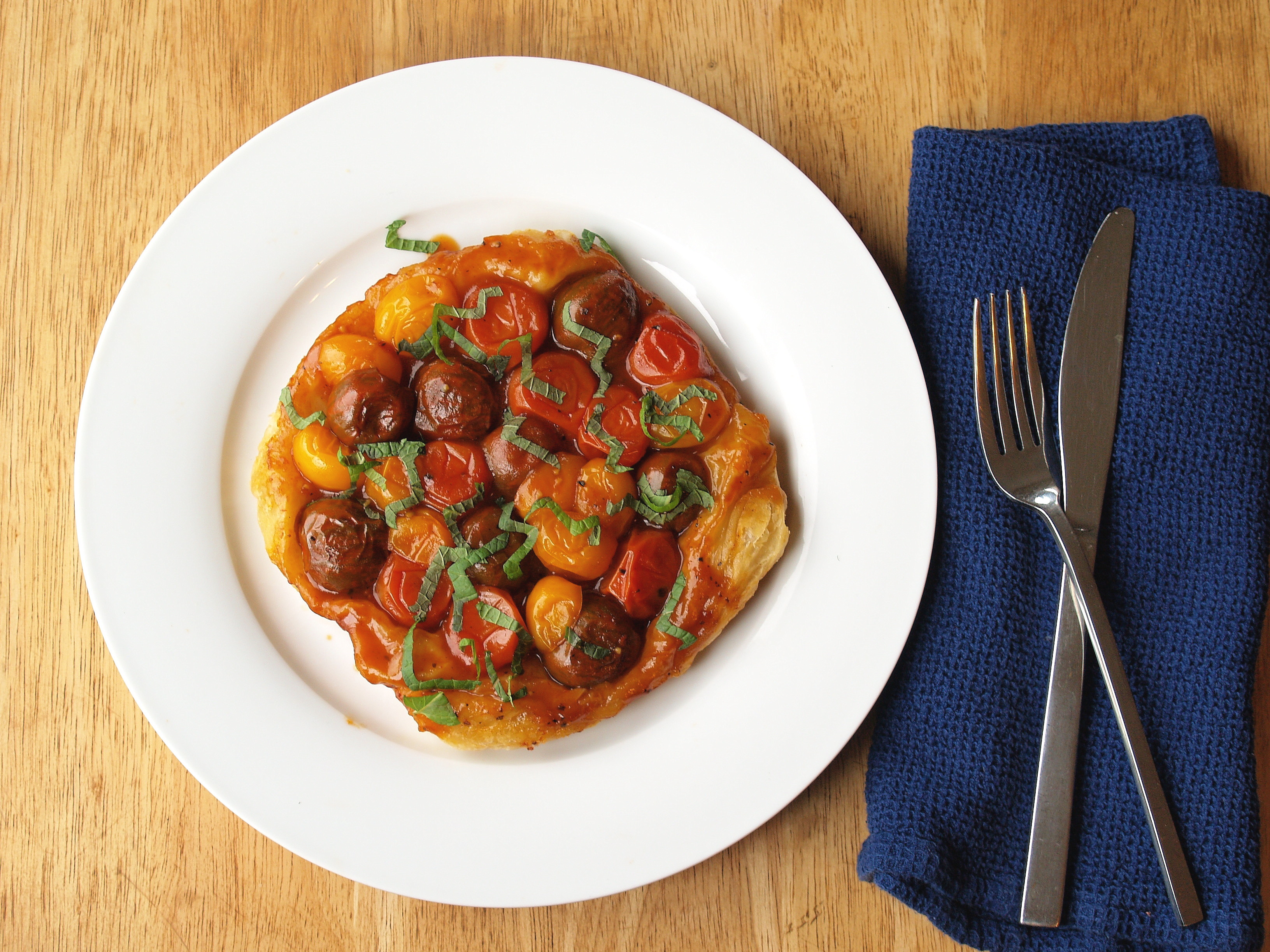 Individual tomato tarte tatin with pomegranate and mint