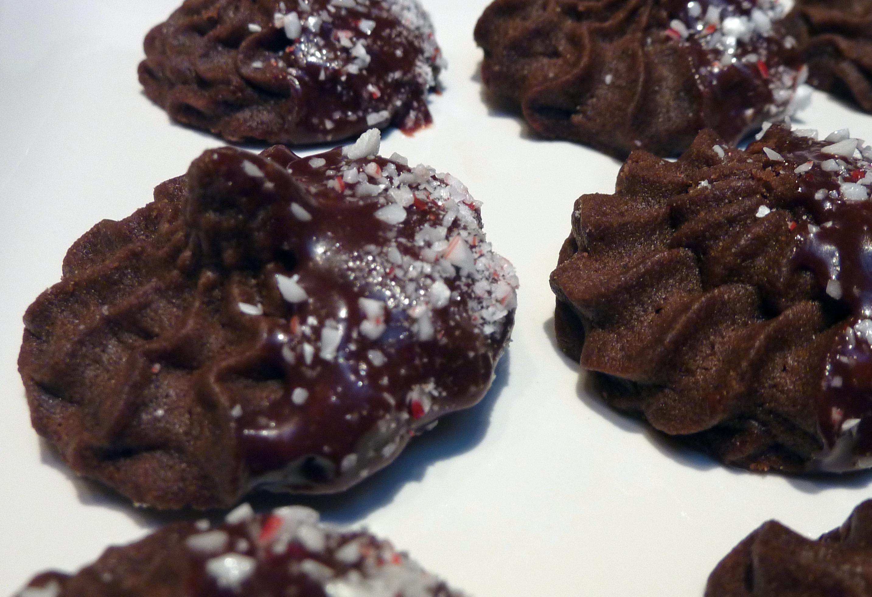 Chocolate Cookies Dipped in Chocolate-Cherry Sauce with Candy Cane Sprinkles