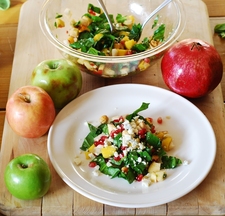 Chopped salad with apples, pears, mango, spinach, hazelnuts, and pomegranates
