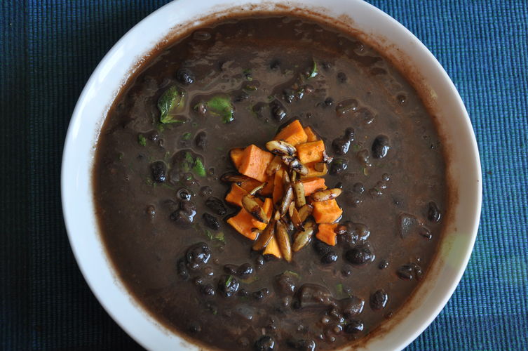 Black Bean Soup Topped with Lime-Toasted Pepitas and Roasted Sweet Potatoes