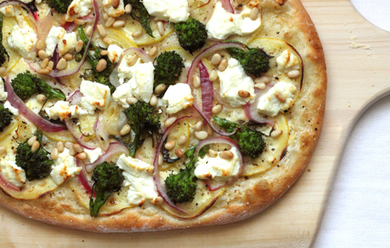 chèvre and rapini pizza with red onion, lemon, and pine nuts