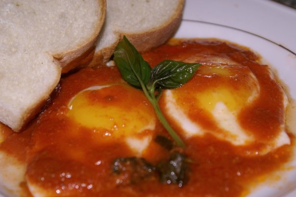 Eggs with a tomatoe and Bazil sauce.