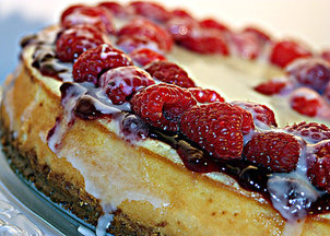 White Chocolate Cheesecake with Raspberry Sauce, Fresh Raspberries and White Chocolate Glaze