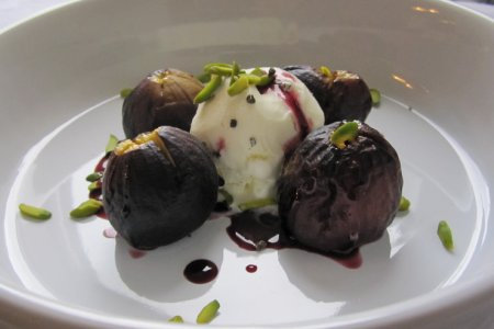 Roasted figs in a red wine cardamom-infused reduction with vanilla ice cream