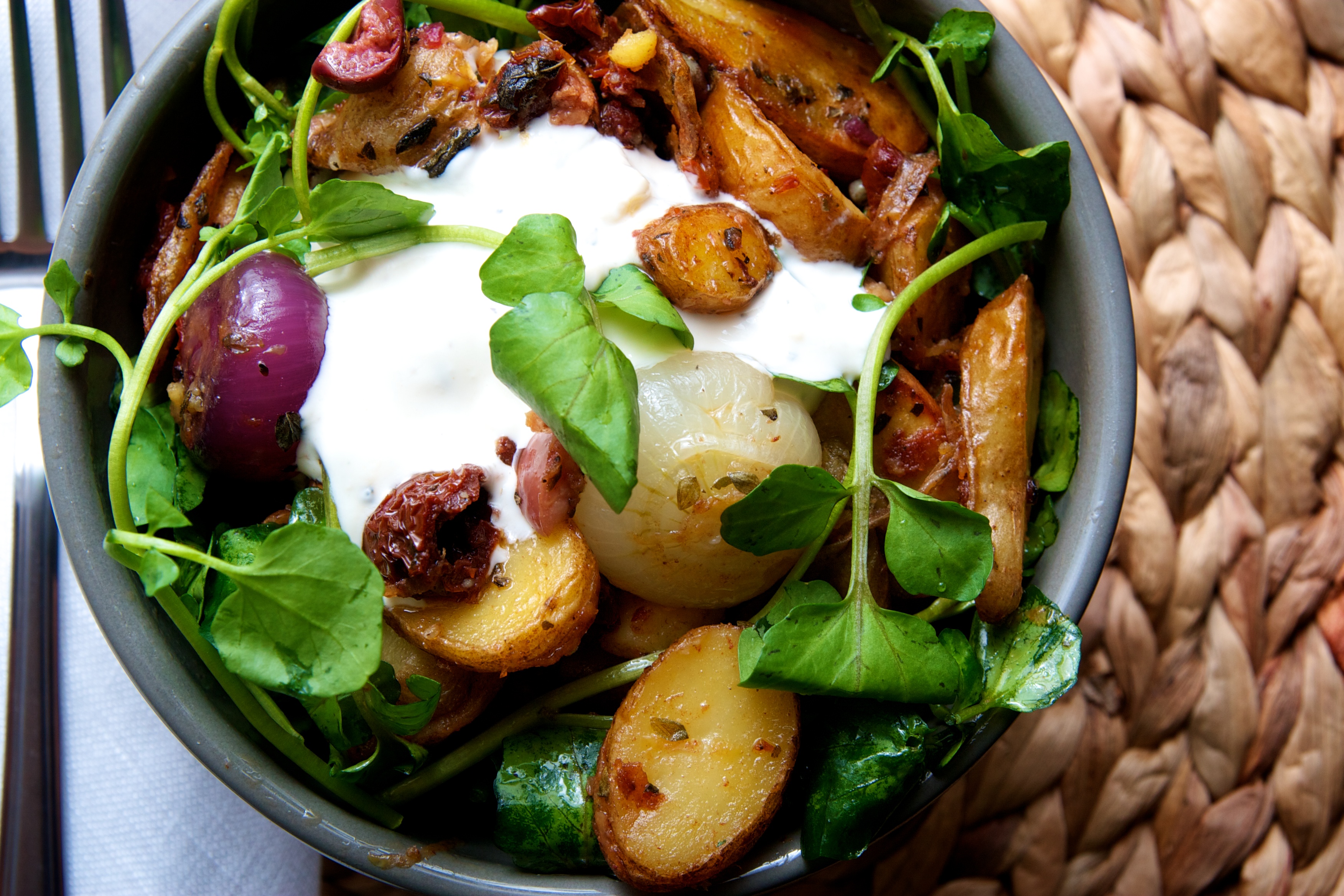 Roasted Fingerling Potatoes & Cipollini Onions with Cress, Sundried Tomatoes, Oregano, & Blue Cheese Crema