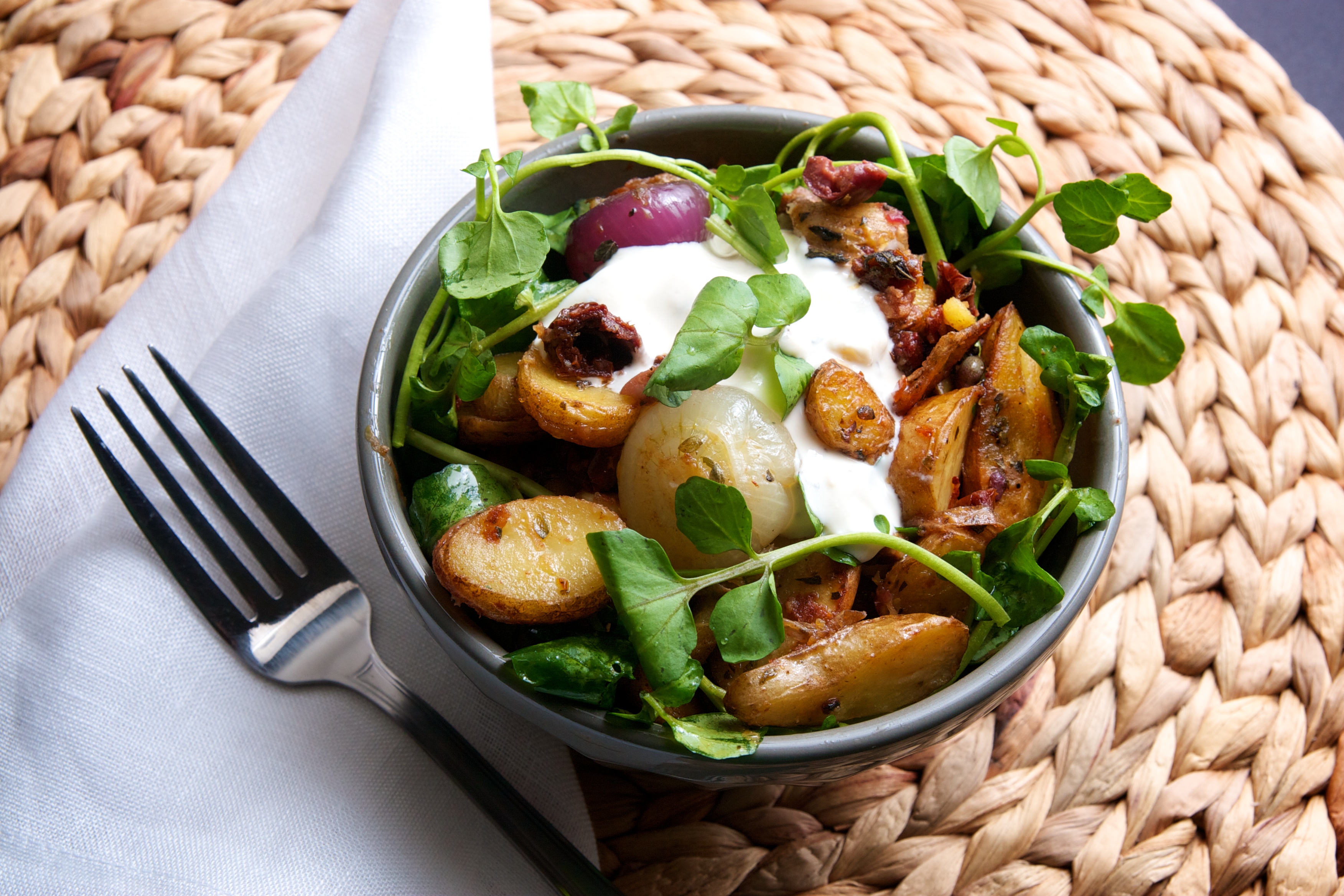 Roasted Fingerling Potatoes & Cipollini Onions with Cress, Sundried Tomatoes, Oregano, & Blue Cheese Crema