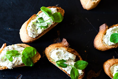 Ramped Up Crostini with Ricotta and Pea Shoots