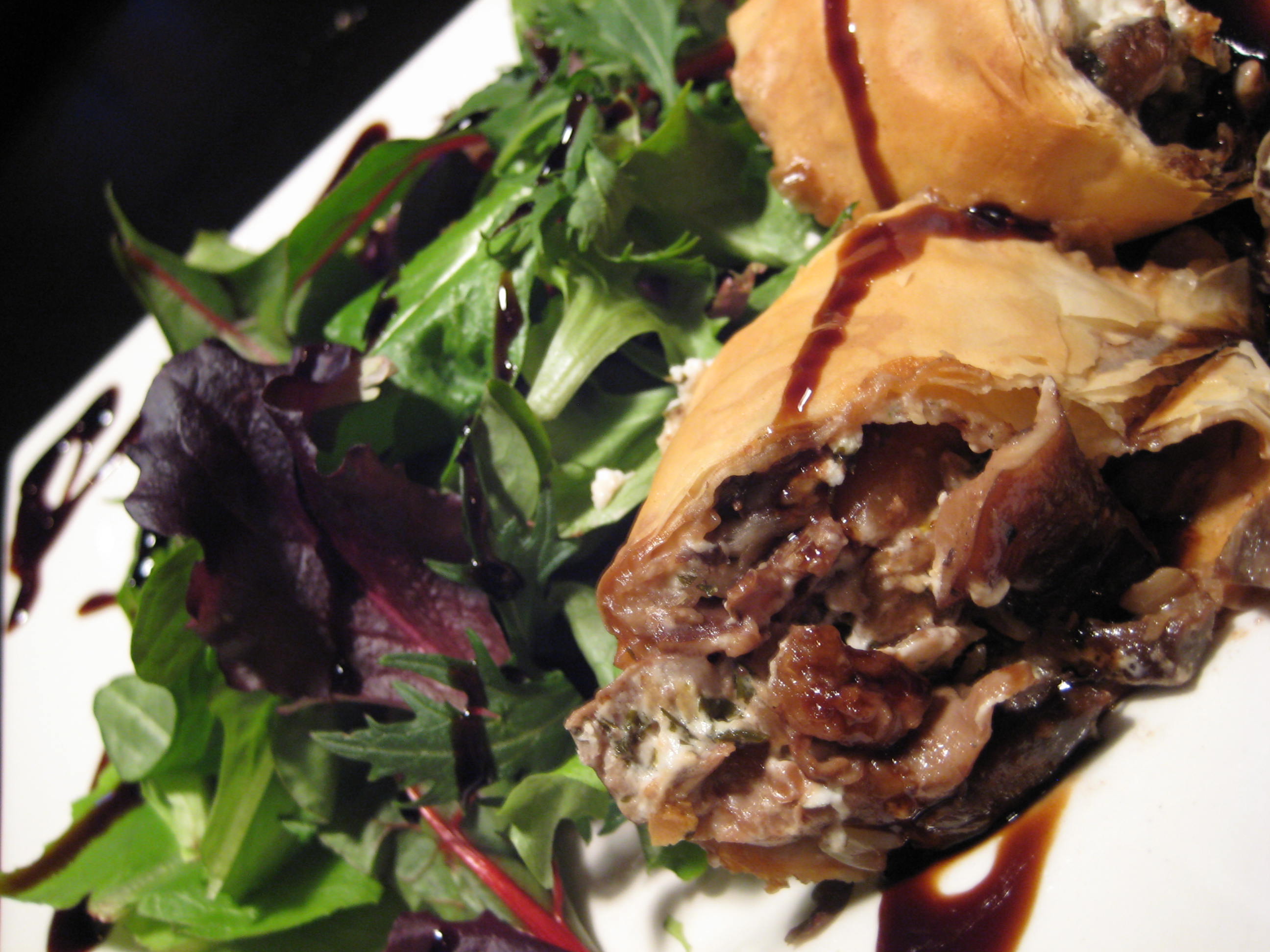Wild Piedmont Mushroom & Goat Cheese Strudel served over Spring Arugula with toasted Pine Nuts