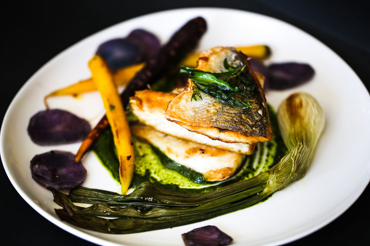 Pan-Fried Branzino with whole roasted scallions and purple potatoes